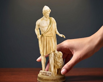 May include: An alabaster statuette of a bearded figure wearing a cap and draped garment, holding a staff with a small animal at their side. The base features the text "THE JOURNEY IS ITS OWN LONAID" and the image includes the text "epic history. timeless art."
