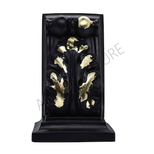 May include: Black corbel with gold leaf accents. The corbel features a stylized leaf design.