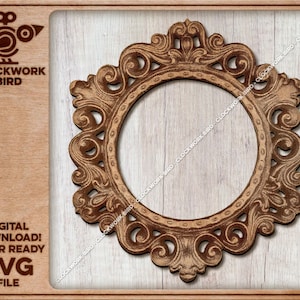 May include: A laser-cut SVG file of a decorative, ornate, circular frame with a brown wood finish. The frame has a detailed, intricate design with swirls and flourishes.