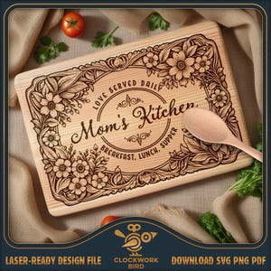 May include: A rectangular wooden cutting board featuring a laser-engraved floral border and the text Mom's Kitchen, Love Served Daily, Breakfast, Lunch, Supper. A light-colored wooden spoon rests on the board, accompanied by fresh red tomatoes.