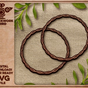 May include: Two brown wooden rings with a braided design, on a beige fabric background.  The rings are overlapping each other.  The image has the text "CLOCKWORK BIRD" and "DIGITAL DOWNLOAD! LASER READY SVG FILE" in the bottom left corner.