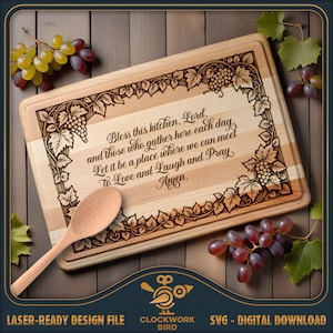 May include: A rectangular wooden cutting board featuring a laser-engraved border of grapevines and clusters of grapes. The center text reads: Bless this kitchen, Lord, and those who gather here each day, Let it be a place where we can meet, To Love and Laugh and Pray, Amen. A wooden spoon rests on the board.