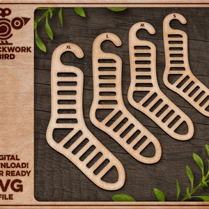 May include: Wooden sock organizers in sizes XL, L, M, and S, with a slotted design. The Clockwork Bird logo is in the upper left corner. The text "DIGITAL DOWNLOAD! LASER READY SVG FILE" is in the lower left corner. The organizers are on a dark wood background.