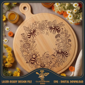 May include: A round wooden cutting board with a handle, featuring a laser-engraved design of three bees surrounded by a circular wreath of various wildflowers. The wood grain is visible, and the engraving is in a dark brown tone.