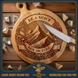 May include: A round wooden cutting board with a handle, featuring a laser-engraved mountain illustration surrounded by ornate scrollwork and the text "BE A VOICE NOT AN ECHO". A silver kitchen knife rests diagonally across the board surface.
