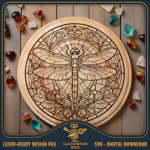 May include: A laser-cut wooden cutting board with a stained glass design of a dragonfly surrounded by floral details. The design is intricate and detailed, with a circular shape. The board is made of natural wood and has a warm brown color.