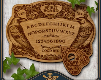 May include: A wooden spirit board with a planchette in the shape of a heart with a skull design. The board features a raven on each side and the letters of the alphabet, numbers 1-9 and 0, and the words "Yes", "No", and "Good Bye".