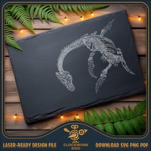 May include: A rectangular black slate board featuring a white laser-engraved illustration of a plesiosaur skeleton. The fossil design shows the creature's long neck, skull, and flippers centered on the textured stone surface with rough edges.