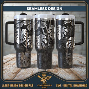 May include: A black and silver stainless steel tumbler with a tropical leaf design. The tumbler has a lid and a handle. The design is seamless and wraps around the entire tumbler.