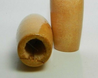 May include: Two wooden bobbins with a natural wood finish. The bobbins are cylindrical with a hole in the center.