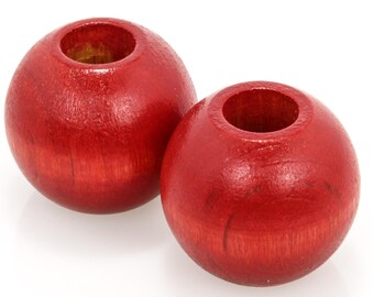 May include: Two red wooden beads with a hole in the center. The beads are smooth and have a slight sheen.