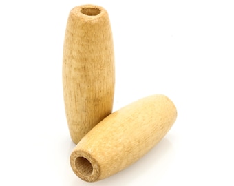 May include: Two cylindrical wooden drawer pulls with a light brown color. One is upright, and the other is lying down. Each has a hole drilled through the center. The wood grain is visible.