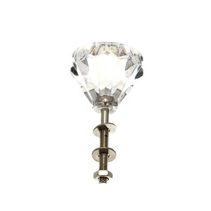 May include: A clear crystal diamond-shaped cabinet knob with a silver metal screw and washers.