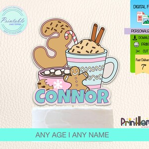May include: A colorful cake topper with a gingerbread man, a mug of hot chocolate, and the name "Connor". The design includes a gingerbread cookie shaped like the number 3, a candy cane, and cinnamon sticks. The text "ANY AGE I ANY NAME" is also included.