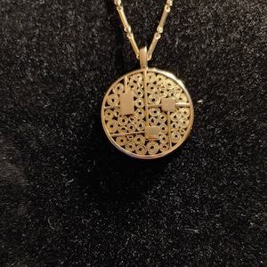 Vintage Sarah Coventry Goldtone Round Pendant with Circles and Squares Decoration on a Long Bar Chain.