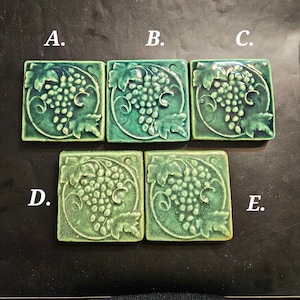 1 Handmade Vintage Grapes Ceramic Tile from Whistling Frog Tile Co. 3 Have Shiny Dark Green Finish 2 Have Matte Dark Green Finish.
