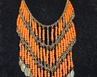 Lovely Vintage Orange Beaded 3 Tiered Bib Necklace. Soft Flowing Goldtone Chain Ending in Goldtone Patterned Leaf Charm Dangles