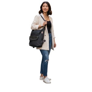 May include: A black canvas backpack with a flap closure and multiple pockets. The bag is worn over the shoulder. The person is wearing a cream-coloured blazer, a black top, and blue jeans with white trainers.
