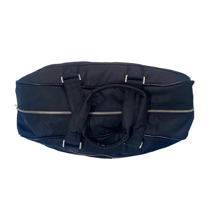May include: A black nylon duffel bag with silver zippers and a top handle.
