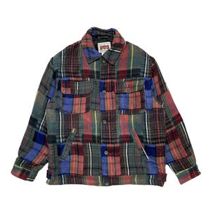 Puede incluir: Chaqueta a cuadros multicolor con cierre de botones, dos bolsillos en el pecho y dos bolsillos laterales. La chaqueta presenta un diseño de patchwork con patrones de cuadros rojos, azules, verdes y amarillos. El cuello es de color gris oscuro.