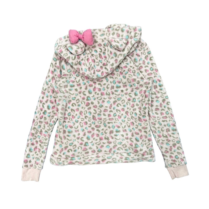 May include: A white hooded sweatshirt with a pink bow on the hood. The sweatshirt has a leopard print pattern in shades of pink, blue, and brown.
