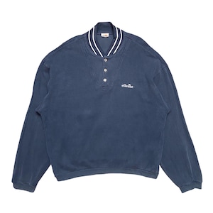 May include: A navy blue long-sleeved sweatshirt with a white ribbed collar and a button-up placket. The sweatshirt has a white "ellesse" logo on the chest.
