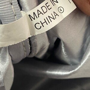 May include: A white label with black text that reads "Made in China" with a circled number 4.