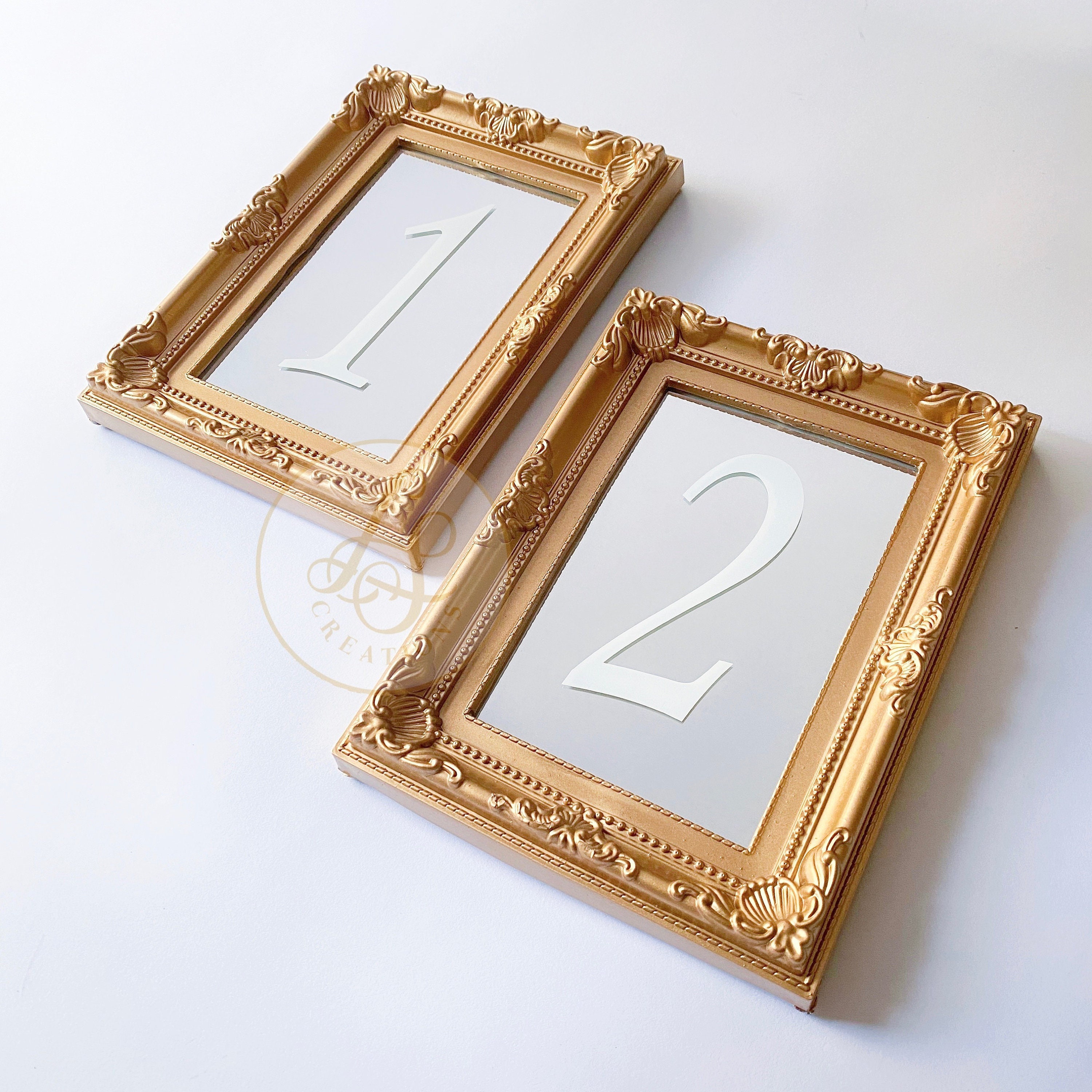 Wedding table number in a gold frame using a gold sharpie on