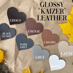 May include: Glossy 'Kaizer' leather swatches in heart shapes. Colors include black, choco, cognac, dark grey, grey, caramel, latte, and white.