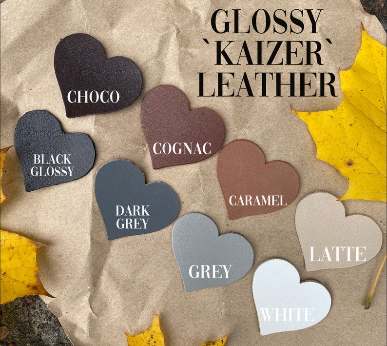 May include: Glossy 'Kaizer' leather swatches in heart shapes. Colors include black, choco, cognac, dark grey, grey, caramel, latte, and white.