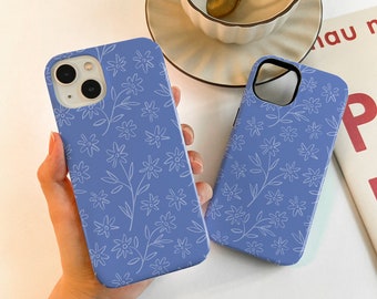 May include: Two phone cases with a blue background and a white floral pattern. The cases are made of a hard plastic material and have a matte finish.