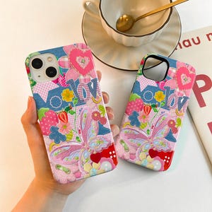 May include: Two pink and blue phone cases featuring a butterfly, flowers, and the word "love" in a patchwork design.