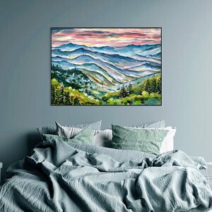 May include: A painting of a mountain range with a pink and purple sky. The mountains are painted in shades of blue, green, and brown. The painting is framed in black.