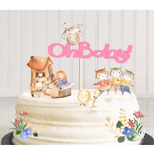 May include: A pink cake topper with the words "Oh Baby!" and a whimsical illustration of a house, a girl, a cow, and animals in a shoe. The cake topper is on a white cake with floral decorations.