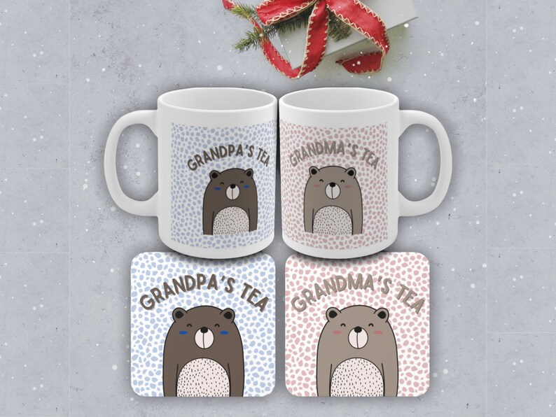 May include: Two white ceramic mugs with brown bear illustrations and the text "Grandpa's Tea" and "Grandma's Tea". Two matching coasters with the same design.