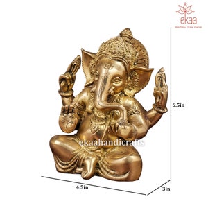 May include: A gold-colored brass statue of Ganesha, the Hindu god of wisdom and prosperity, sitting in a meditative pose. The statue is 6.5 inches tall, 4.5 inches wide, and 3 inches deep.