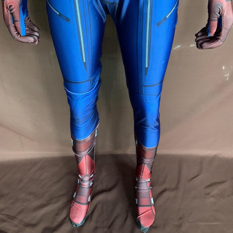May include: Blue and red spandex costume with a zipper detail on the legs and boots. The boots are red with black and white details.