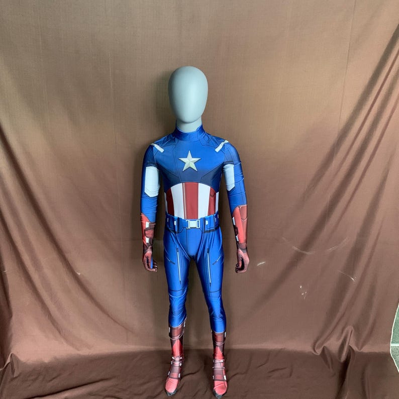 May include: A blue and red superhero costume with a white star on the chest. The costume is made of a stretchy material and has a zipper at the back. The costume is on a mannequin.