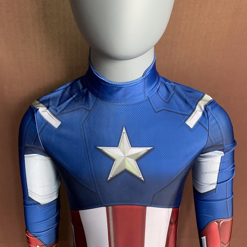 May include: A blue and red superhero costume with a white star on the chest. The costume is made of a stretchy fabric and has a high neck.