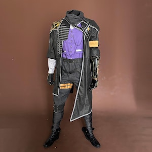 May include: A complete costume featuring a black coat with gold accents, a purple button-up shirt, and black pants. The outfit includes black gloves, boots, and a neck scarf. The costume has a detailed design with multiple layers and textures.