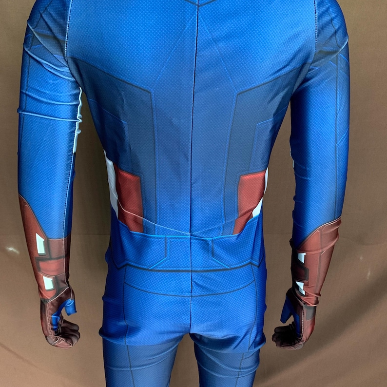 May include: A blue and red spandex costume with a star on the chest. The costume has long sleeves and pants.