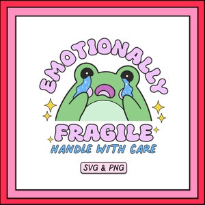 May include: A green frog with pink and blue eyes is crying. The frog is surrounded by a pink and blue circle with the text "Emotionally Fragile Handle With Care" in pink and blue letters. The text "SVG & PNG" is in a white rectangle with a pink border.