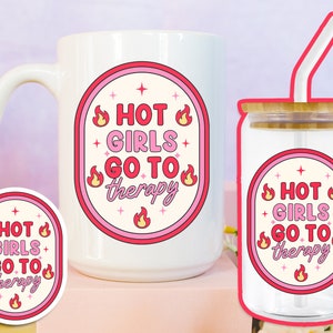 May include: A set of two pink and white mugs with the text "Hot Girls Go To Therapy" and a flame graphic. The mug on the left is a standard coffee mug, while the mug on the right is a glass tumbler with a straw.