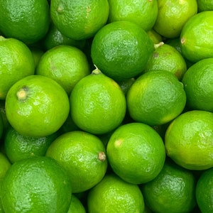 a close-up of a bowl of key limes zoomed in