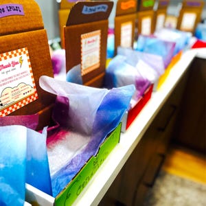 custom box assembly line prep work for candy boxes care care package