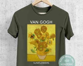 May include: A green t-shirt with a print of a painting by Van Gogh featuring a vase of sunflowers. The text "VAN GOGH" and "SUNFLOWERS" is printed below the image. The text "WATER BASED INKS ECO NON-TOXIC PVC FREE" is printed in a circle on the bottom right of the shirt.