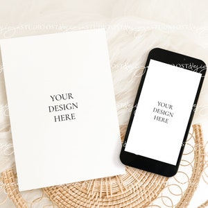 May include: A white card and a black smartphone mockup on a woven wicker surface with a white sheer fabric background. The card and phone both have the text "Your Design Here".