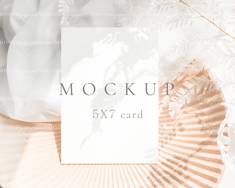 May include: A white card mockup with the text "MOCKUP" and "5X7 card" on a light brown background with white fern leaves and shadows.