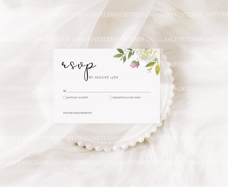 May include: White RSVP card with a floral design in the top right corner. The card has a section for guests to indicate whether they will be attending the event by August 15th. The card also includes a section for dietary requirements.