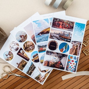 May include: A set of four sheets of stickers featuring images of Ireland. The stickers are printed on white paper and have a glossy finish. The images include a sheep, a lighthouse, a boat, a pub, a street scene, and a flag. The stickers are labeled "Ireland" and "Ireland 2".